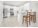 Modern kitchen with stainless steel appliances, white cabinets, and wooden bar stools at 11312 Fox Hill Dr, Charlotte, NC 28269