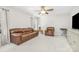 Cozy living room featuring a leather sofa, armchair, and neutral carpeting at 11312 Fox Hill Dr, Charlotte, NC 28269