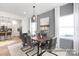 Elegant dining room with a rustic wood table, seating for six, neutral decor, and bright natural light at 11331 Magpie Ct # 7, Charlotte, NC 28215