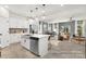 Open concept kitchen with island seating, stainless steel appliances, flowing into the dining and living area for seamless living at 11331 Magpie Ct # 7, Charlotte, NC 28215