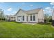 Inviting backyard features a well-maintained lawn, white vinyl siding, and a black metal fence at 117 Pine Lake Dr, Monroe, NC 28110