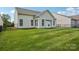 This spacious backyard offers a well-kept lawn, vinyl siding, and a secure black metal fence at 117 Pine Lake Dr, Monroe, NC 28110