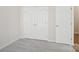A bedroom with carpet features a double door closet, and a door to the right at 117 Pine Lake Dr, Monroe, NC 28110