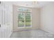 Bright bedroom with large windows offering natural light, complemented by neutral walls and plush carpet at 117 Pine Lake Dr, Monroe, NC 28110