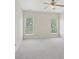 Spacious, light-filled bedroom with neutral carpet and ample window views at 117 Pine Lake Dr, Monroe, NC 28110