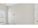 A neutral bedroom with a window, wall outlets, and a door on the right at 117 Pine Lake Dr, Monroe, NC 28110