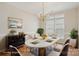 Elegantly staged dining room with a gold chandelier, sleek buffet, and seating for six, perfect for hosting dinner parties at 117 Pine Lake Dr, Monroe, NC 28110