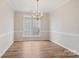 A bright dining room featuring hardwood floors, and ample light from large window at 117 Pine Lake Dr, Monroe, NC 28110