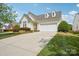 Charming home featuring a two-car garage, dormer windows, and a well-manicured front lawn at 117 Pine Lake Dr, Monroe, NC 28110