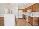 Open kitchen with white appliances, wooden cabinets, and island; perfect for gatherings at 117 Pine Lake Dr, Monroe, NC 28110