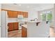 Well-lit kitchen featuring a breakfast bar, modern appliances, and ample cabinet space for a functional cooking environment at 117 Pine Lake Dr, Monroe, NC 28110