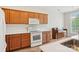 Well-lit kitchen with wooden cabinetry, white countertops, and appliances, including a microwave and range at 117 Pine Lake Dr, Monroe, NC 28110