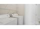 Functional laundry room with washer, dryer, and wire shelving for storage at 117 Pine Lake Dr, Monroe, NC 28110