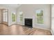 Bright living room featuring a cozy fireplace and backyard access at 117 Pine Lake Dr, Monroe, NC 28110