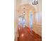 Elegant hallway featuring hardwood floors, arched doorways, decorative moldings, and pendant lighting at 1215 39Th Ne Ave, Hickory, NC 28601