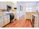 Bright kitchen features stainless steel appliances, granite countertops, and hardwood floors at 1215 39Th Ne Ave, Hickory, NC 28601