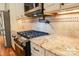 Gourmet kitchen featuring granite countertops, stainless steel appliances, custom cabinets, and tile backsplash at 1215 39Th Ne Ave, Hickory, NC 28601
