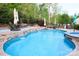 Inviting pool with multiple water features and ample seating areas surrounded by mature landscaping at 1215 39Th Ne Ave, Hickory, NC 28601