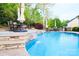 Relaxing pool featuring a stone waterfall, lush landscaping, and plenty of seating at 1215 39Th Ne Ave, Hickory, NC 28601