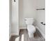 Well lit bathroom with wood grain floors and stainless steel hardware at 1305 Foxfield Rd # 60, Waxhaw, NC 28173