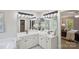 Bright bathroom with dual sinks, updated fixtures, and an adjacent room with a walk-in closet at 1305 Foxfield Rd # 60, Waxhaw, NC 28173
