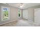 Bedroom featuring two windows, a closet, a ceiling fan, and neutral walls at 1305 Foxfield Rd # 60, Waxhaw, NC 28173