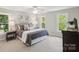 Bright bedroom with neutral walls, plush bedding, ample natural light, and tasteful decor at 1305 Foxfield Rd # 60, Waxhaw, NC 28173