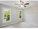 Bright bedroom with carpet, two windows providing natural light, and a ceiling fan at 1305 Foxfield Rd # 60, Waxhaw, NC 28173