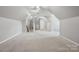 Large bonus room features neutral carpet and flexible space at 1305 Foxfield Rd # 60, Waxhaw, NC 28173