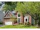 Charming brick home with lush green lawn, mature trees, and meticulously maintained landscaping at 1305 Foxfield Rd # 60, Waxhaw, NC 28173