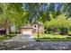 Traditional brick home on a tree-lined street featuring a spacious driveway and well-kept front yard at 1305 Foxfield Rd # 60, Waxhaw, NC 28173