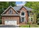 Beautiful brick home with attached two-car garage and manicured lawn, offering classic curb appeal at 1305 Foxfield Rd # 60, Waxhaw, NC 28173