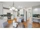 Open kitchen with white cabinetry, stainless appliances, and a cozy breakfast nook with seating at 1305 Foxfield Rd # 60, Waxhaw, NC 28173