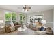 Bright living room with backyard view, ceiling fan, plush seating, and an opening to the kitchen at 1305 Foxfield Rd # 60, Waxhaw, NC 28173