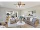 A bright living room boasts neutral tones, plush seating, ceiling fan and an opening to the kitchen at 1305 Foxfield Rd # 60, Waxhaw, NC 28173