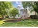 Charming home with a wood deck, large windows, mature trees and green lawn at 1305 Foxfield Rd # 60, Waxhaw, NC 28173
