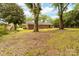A spacious backyard featuring mature trees, lush greenery, and a swing hanging from a tree at 1307 Armstrong Rd, Belmont, NC 28012