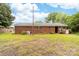 A large backyard with a brick house, ample green space, and mature trees at 1307 Armstrong Rd, Belmont, NC 28012