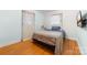 A cozy bedroom showcases hardwood floors, a comfortable bed, and unique patterned curtains at 1307 Armstrong Rd, Belmont, NC 28012