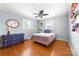 A bright bedroom features hardwood floors, ample natural light, and a unique ceiling fan at 1307 Armstrong Rd, Belmont, NC 28012