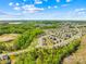 Scenic aerial view of neighborhood surrounded by lush greenery with distant city skyline at 13547 Roderick Dr, Huntersville, NC 28078
