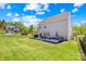 Lush backyard featuring a well-maintained lawn, patio with seating, and secure fencing for privacy and enjoyment at 13547 Roderick Dr, Huntersville, NC 28078
