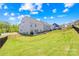 Sprawling backyard featuring a lush lawn, a patio area with seating, and secure fencing for privacy and play at 13547 Roderick Dr, Huntersville, NC 28078