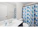 Clean bathroom featuring a single sink vanity, toilet and bathtub with blue, green and white curtain at 13547 Roderick Dr, Huntersville, NC 28078