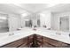 Elegant bathroom featuring double sinks with dark wood cabinets, large mirrors, and modern fixtures at 13547 Roderick Dr, Huntersville, NC 28078