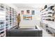 Unique bedroom featuring an extensive sneaker collection display and a modern black leather couch at 13547 Roderick Dr, Huntersville, NC 28078