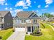 Charming two-story home with a two-car garage, brick and siding exterior, and manicured lawn at 13547 Roderick Dr, Huntersville, NC 28078