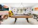 Fun game room boasts a billiard table, arcade games, and a brick accent wall, offering a perfect space for entertainment at 13547 Roderick Dr, Huntersville, NC 28078