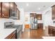 Bright, modern kitchen boasts stainless steel appliances, dark cabinets, and hardwood floors at 13547 Roderick Dr, Huntersville, NC 28078