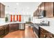 Updated kitchen featuring white countertops, dark wood cabinets, stainless steel appliances, and hardwood floors at 13547 Roderick Dr, Huntersville, NC 28078